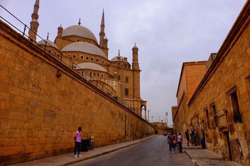 a photo showing the street with the Salah Al deen mosque in behind the walls