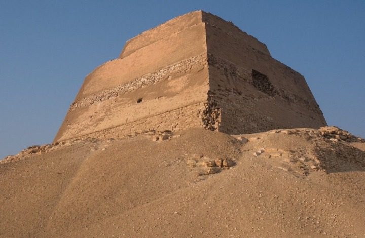 a photo showing a tower looking pyramid on top of a hill