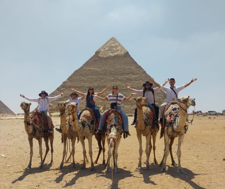 a photo showing a group of people taking a photo in front of the great pyramid of Giza in Egypt
