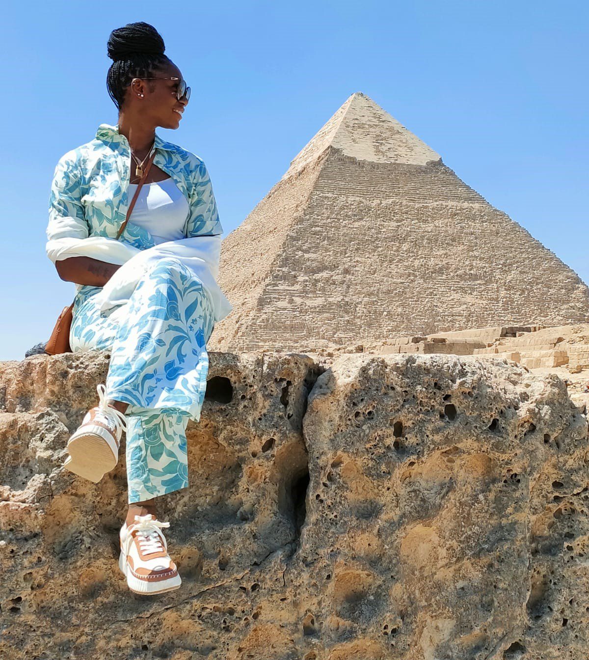 a photo of a tourist who is enjoying a private tour and taking a photo with the Pyramids, Real Egypt Tours