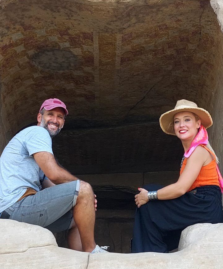 a photo showing 2 tourists smiling in the middle of the Real Egypt Tours