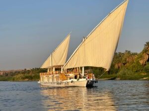 a photo showing a dahabiya in the middle of the Nile in Egypt