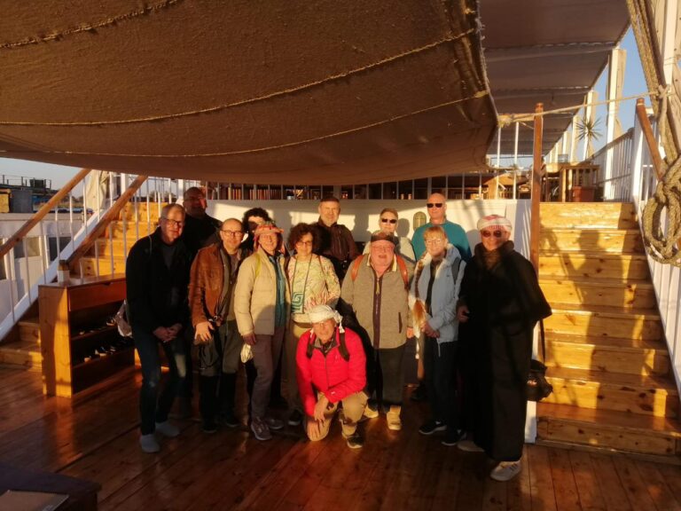 a photo showing some tourists posing for a photo on the Dahabiya deck