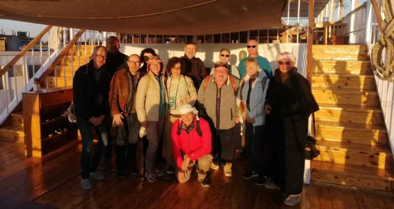 a photo showing some tourists posing for a photo on the Dahabiya deck